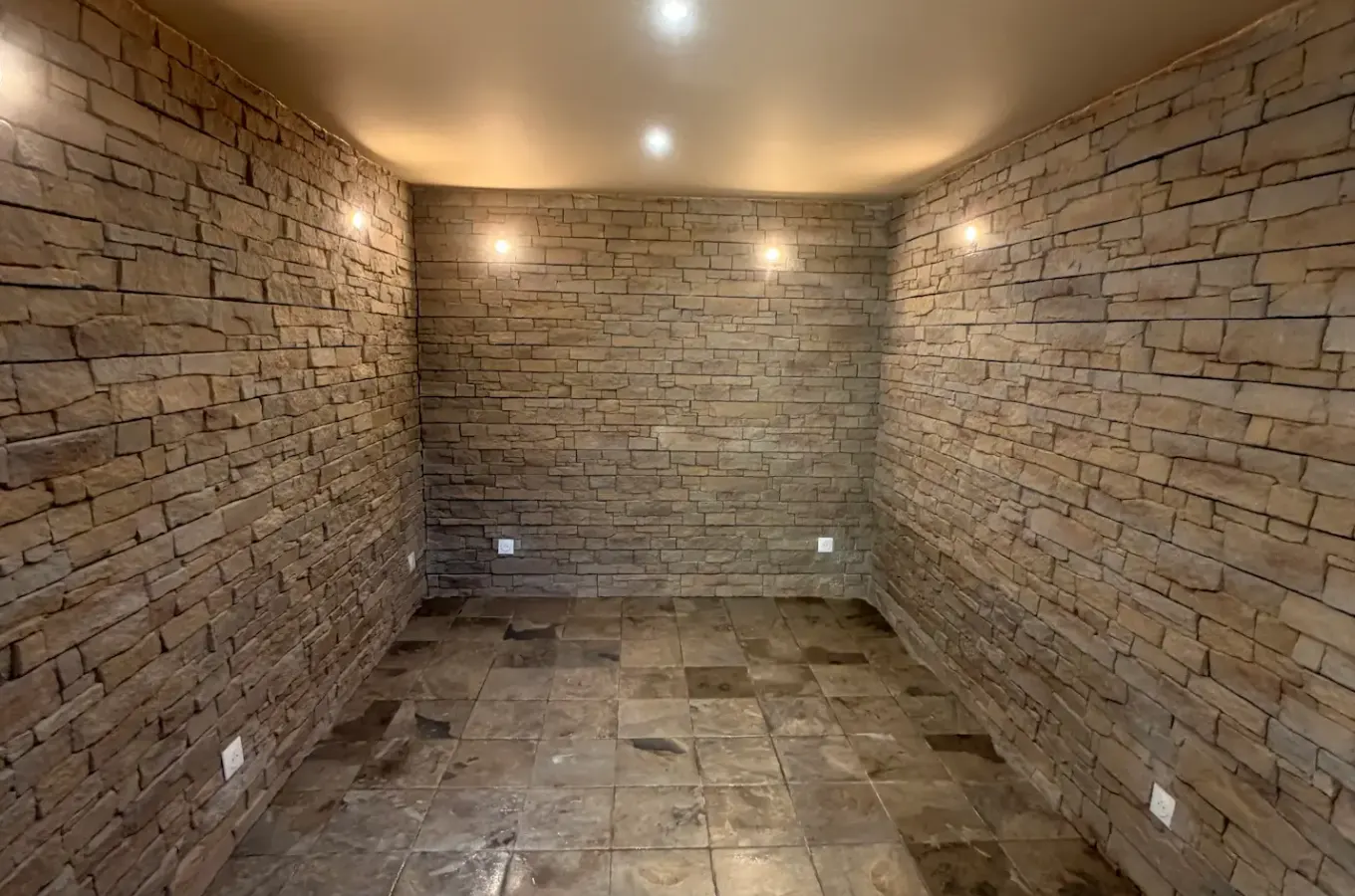 Cave aménagée avec parement en pierre et carrelage